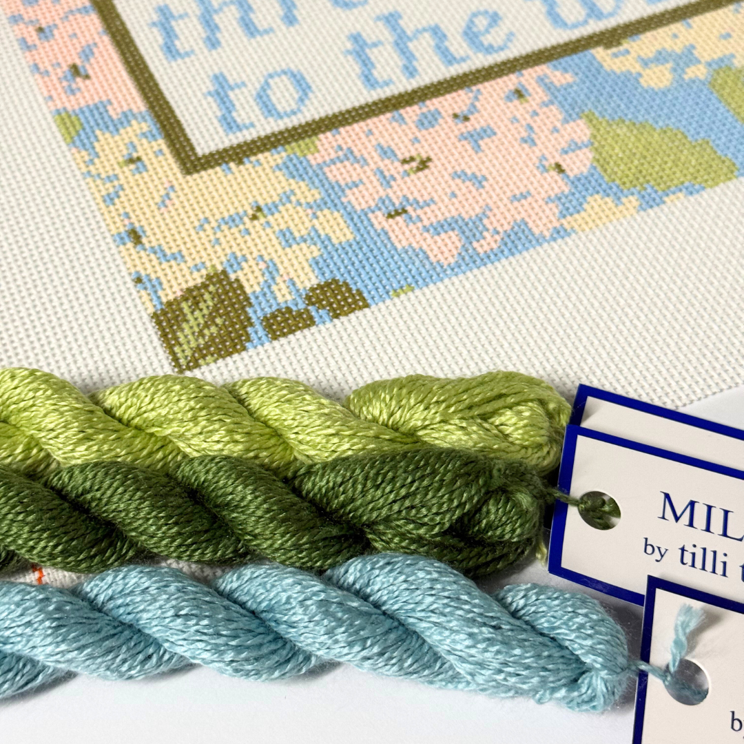 Needlepoint Kit with green and blue yarn, featuring a label for 'Milan by Tilli Tomas'.