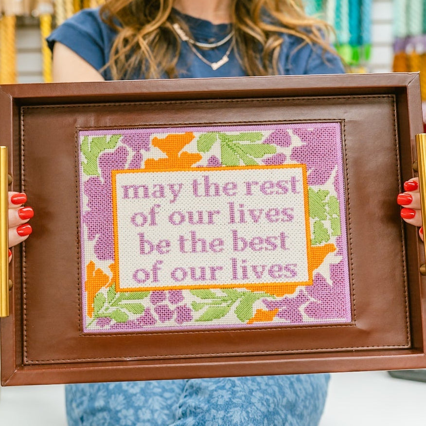 Woman holding a framed motivational quote in a craft store
