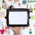 Needlepoint Self-Finishing Black Pouch background with various small objects.