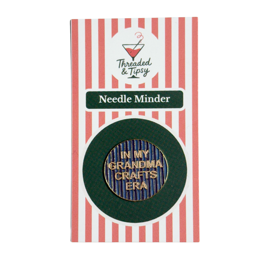 Needle minder with 'In my grandma crafts era' text on a striped packaging