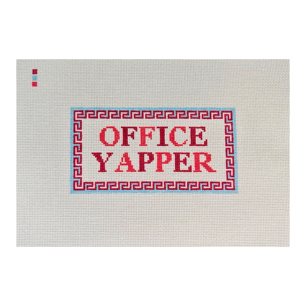 Threaded & Tipsy hand-painted needlepoint canvas featuring the phrase “OFFICE YAPPER” in bold red and burgundy block letters. The text is centered within a red Greek key-style border outlined in light blue. A small painted color guide with three swatches 