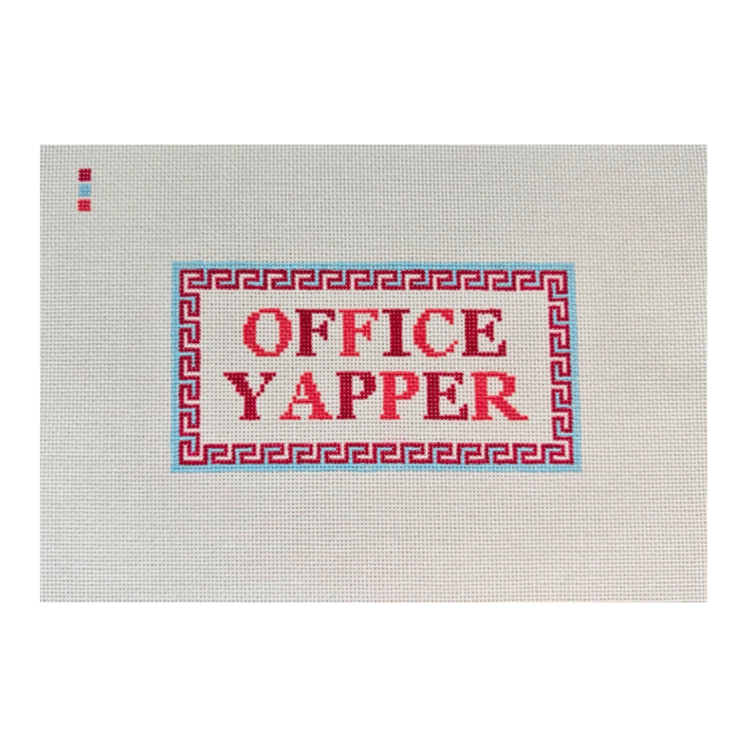 Threaded & Tipsy hand-painted needlepoint canvas featuring the phrase “OFFICE YAPPER” in bold red and burgundy block letters. The text is centered within a red Greek key-style border outlined in light blue. A small painted color guide with three swatches 